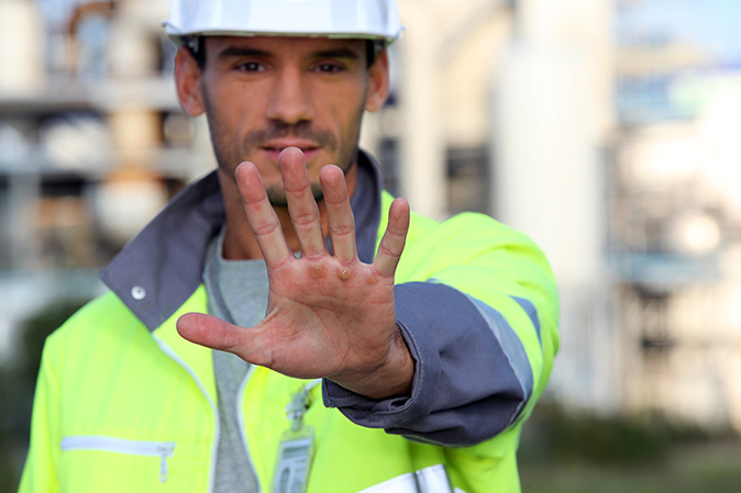 Site foreman indicating 'stop' with hand
